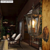 Vintage Clear Glass Wall Sconce: Tapered Single-Bulb Courtyard Lamp