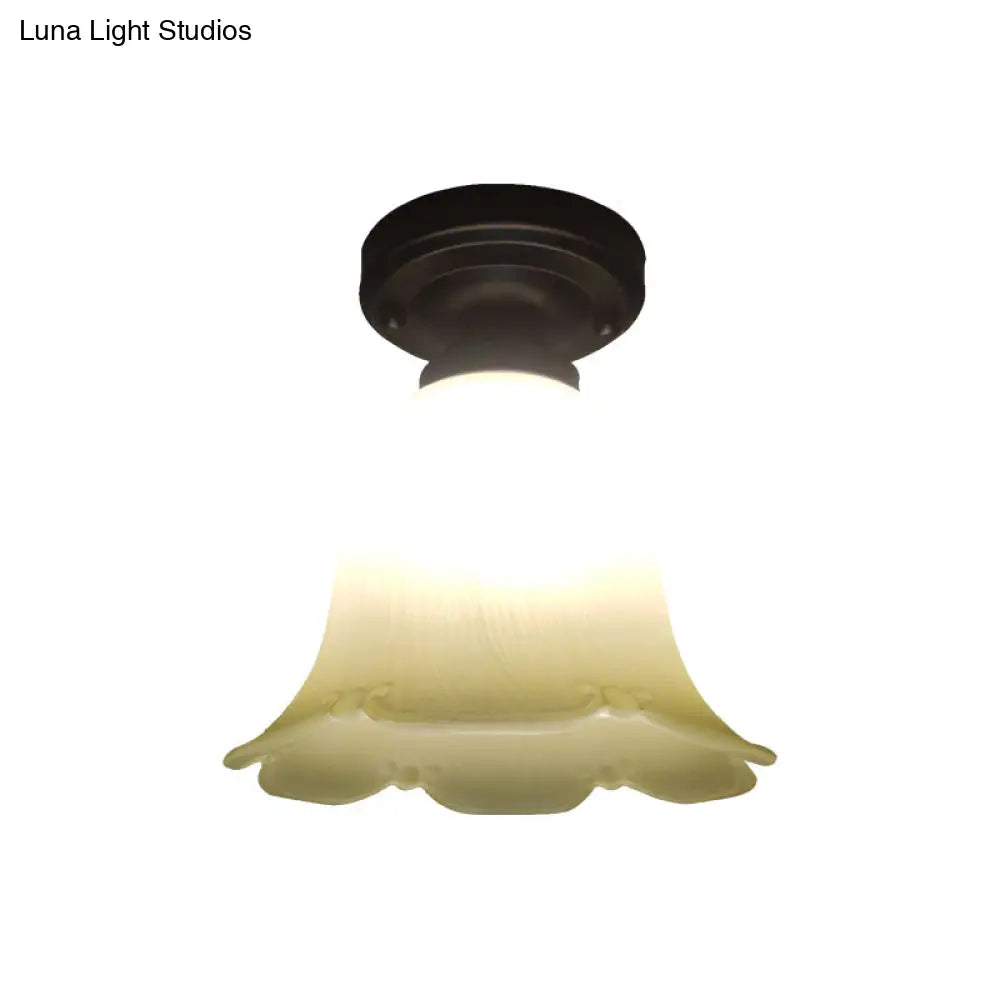 White Glass Flush Mount Ceiling Light With Black Base And Cottage Flower Design