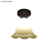 White Glass Flush Mount Ceiling Light With Black Base And Cottage Flower Design